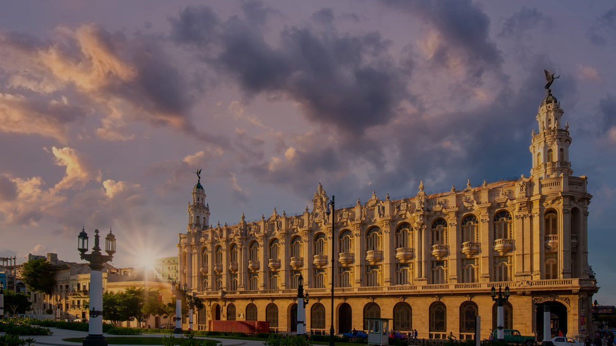 The Gran Teatro de La Habana at dusk under a dramatic evening sky