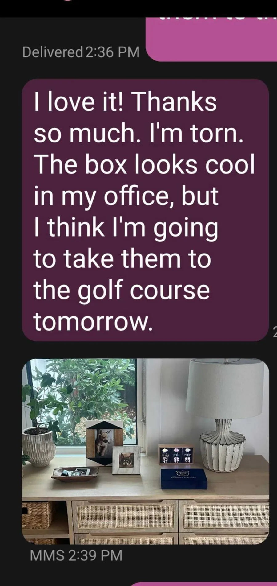 A text message thanking the sender for the box, with a photo of it displayed on a shelf